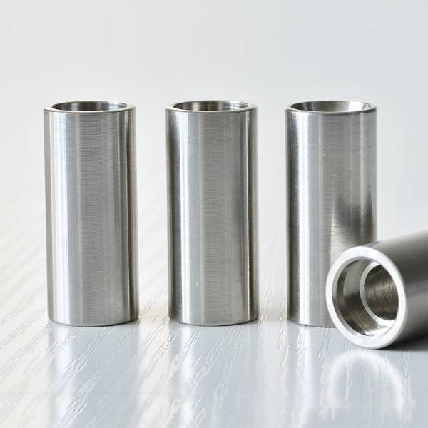 Four QLA-001 hose ferrules on table
