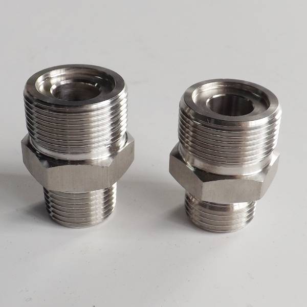 Two QLA-005 hydraulic adapters on gray background