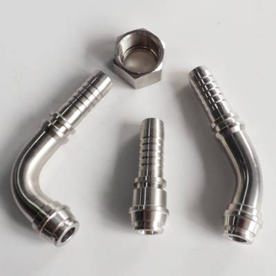 Three O-ring metric 24 degree cones and a nut on the gray background